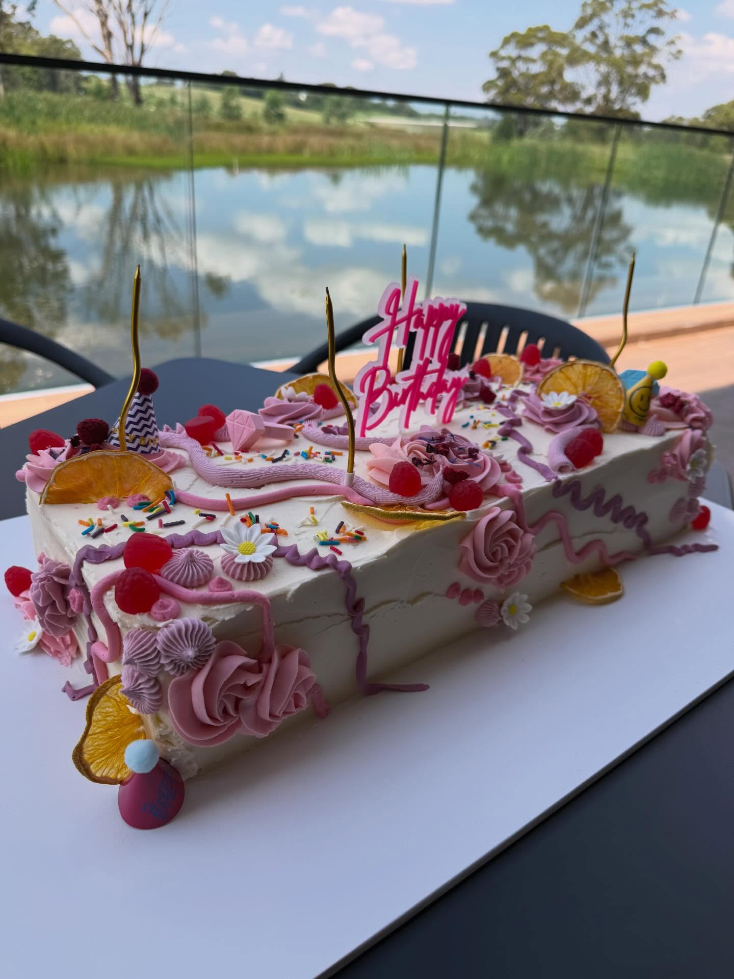 A decorated celebration cake by the lake